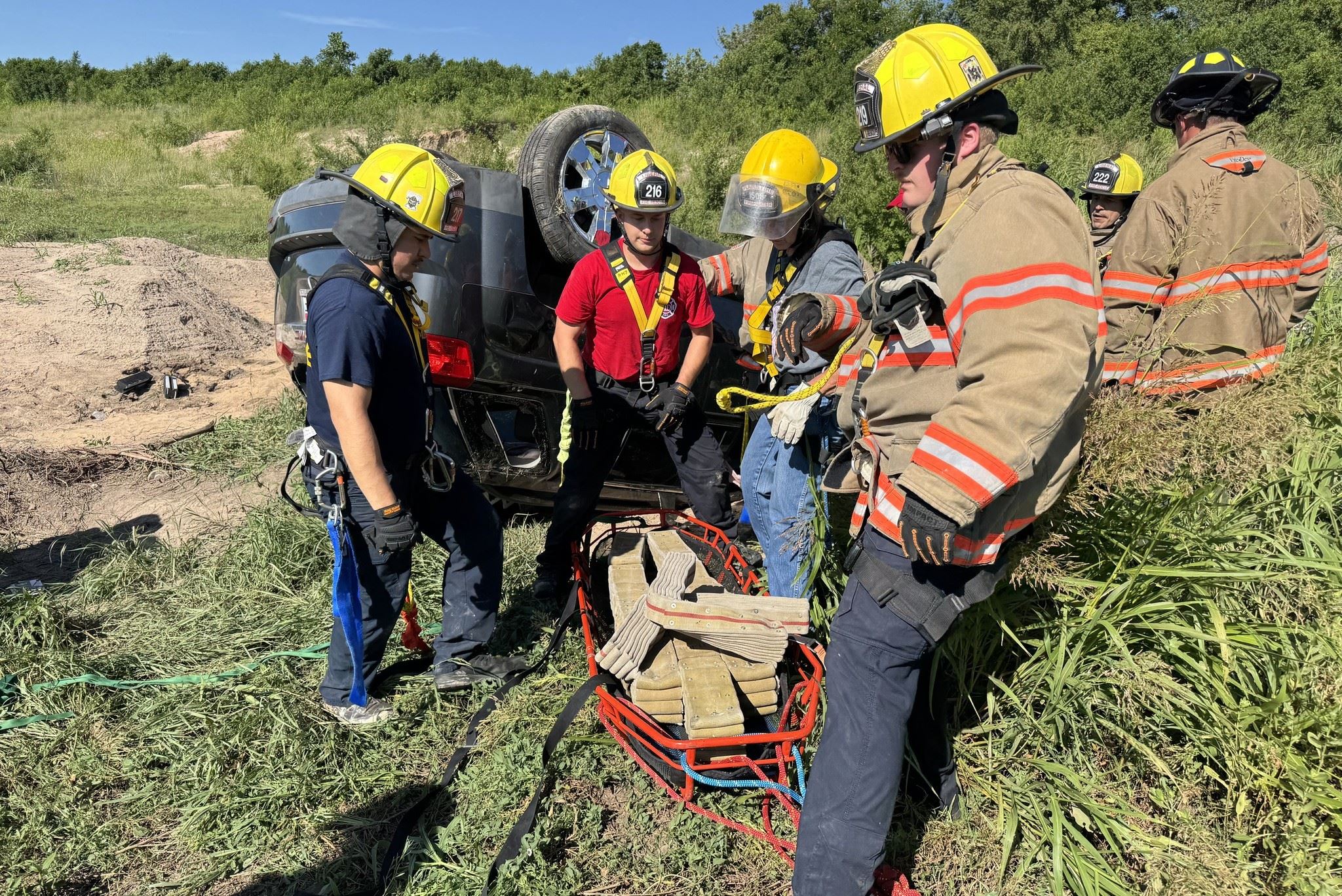 Firefighters perform a vehicle extrication rescue exercise.