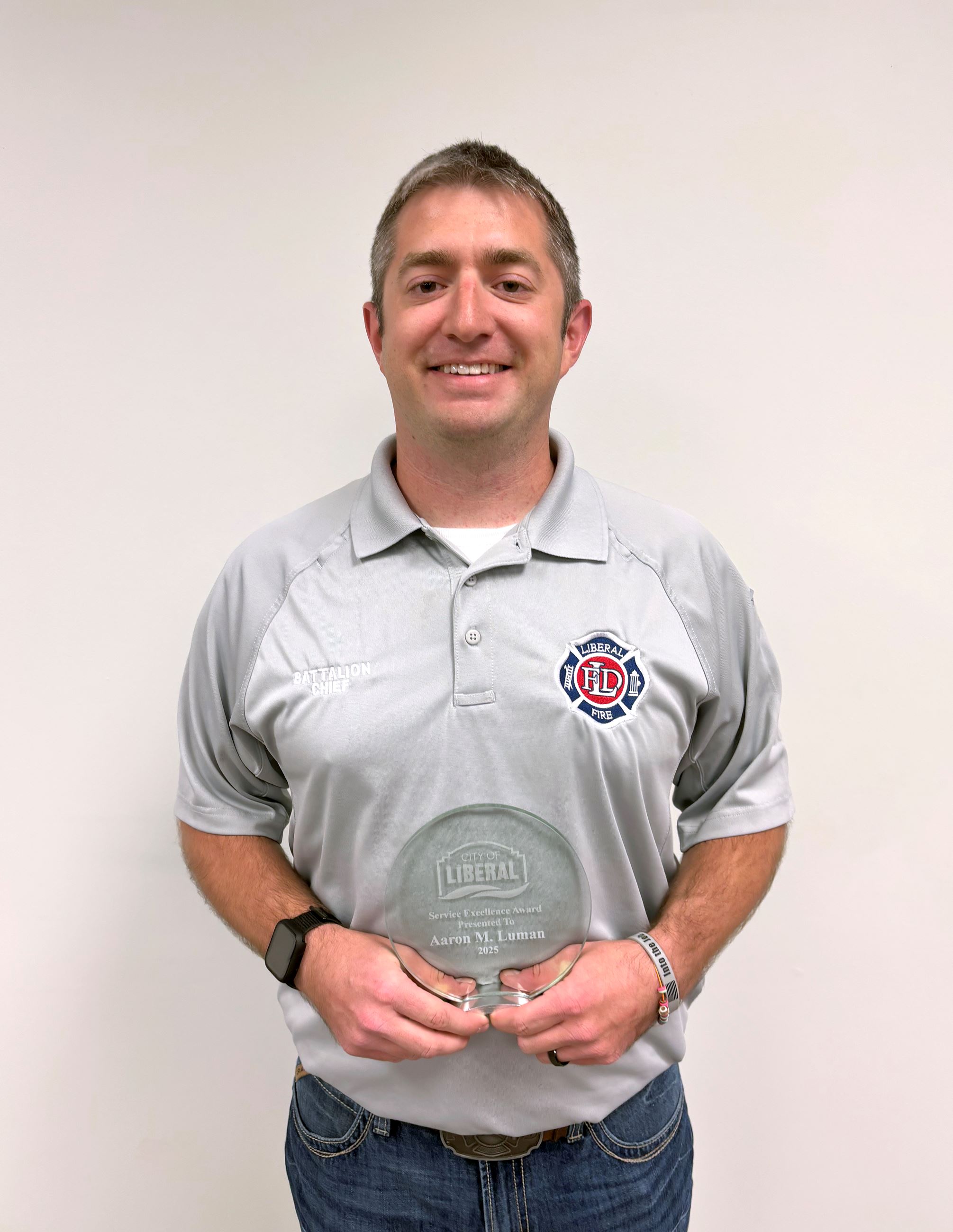 Aaron Luman holds his employee recognition award